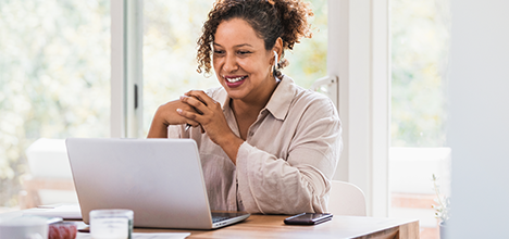 woman smiling using laptop